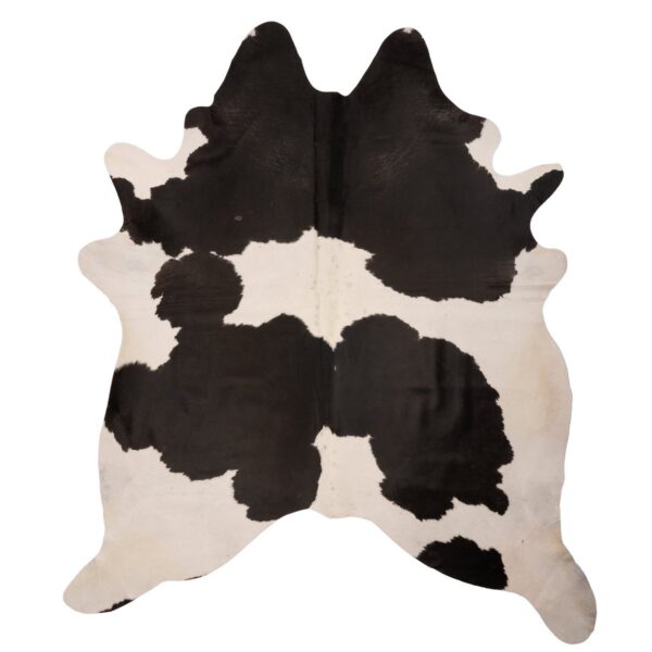 Un tapis peau de vache pure noir et blanc sur un fond blanc.
