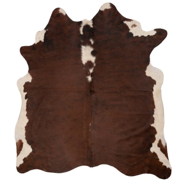 Un tapis Tapis peau de vache doux sur fond blanc.