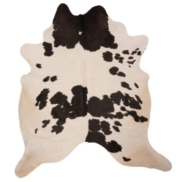 Un tapis peau de vache avec des taches noir | 210x180 cm sur un fond blanc.