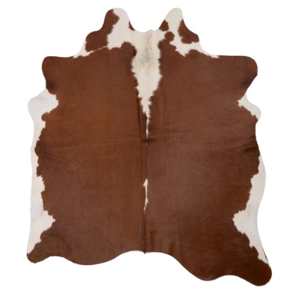 Un Tapis XL peau de vache véritable sur fond blanc.