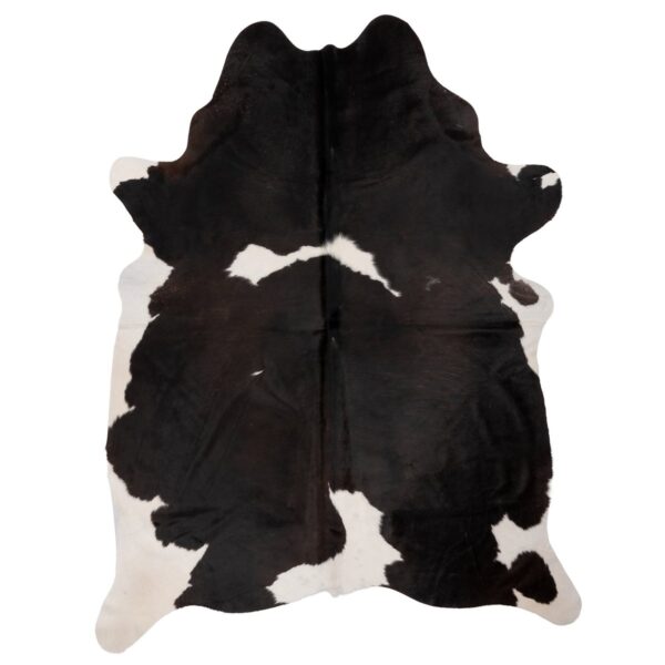Un Tapis peau de vache pour bureau | 210x180 cm noir et blanc sur un bureau.