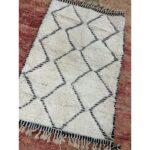 A Tapis Beni Ouarain beige | Tapis 160x104 cm avec pompons dessus.