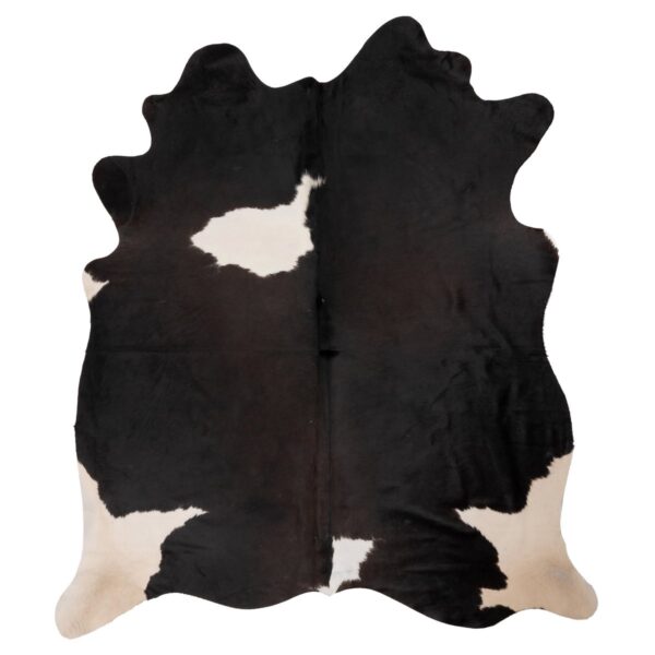 Un tapis peau de vache XL noir et blanc sur fond blanc.