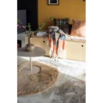 Un tapis rond dans un salon avec des murs.