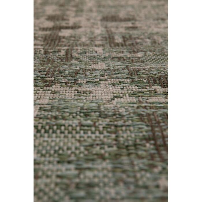 Un gros plan d'un tapis vert et blanc.