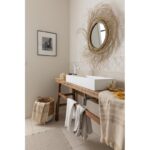 Une salle de bain avec une vasque en bois et un miroir.