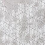 Tapis texturé gris avec motifs géométriques.