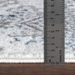 Règle mesurant épaisseur d'un tapis.