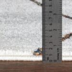 Épaisseur de tapis mesurée en centimètres et pouces.