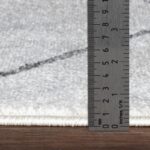 Règle mesurant épaisseur tapis en millimètres.