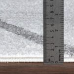 Règle mesurant épaisseur de tapis.