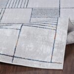 Tapis design géométrique gris et bleu.