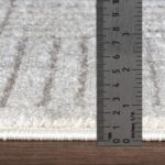 Règle mesurant épaisseur de tapis.