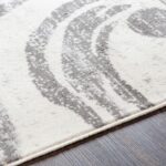 Tapis beige à motifs géométriques gris modernes.