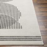 Tapis moderne beige et gris sur parquet.