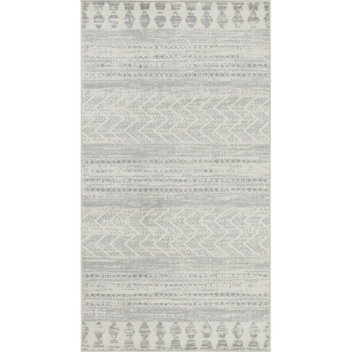 Tapis motifs tribaux gris et blancs.