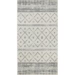 Tapis motifs géométriques gris et blanc.