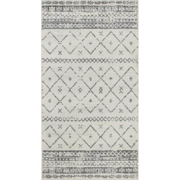 Tapis motifs géométriques gris et blanc.