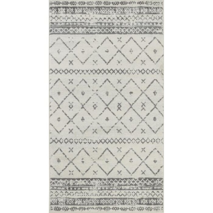 Tapis motifs géométriques gris et blanc.