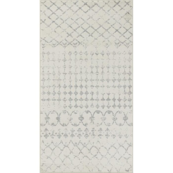 Tapis à motifs géométriques gris et blanc.