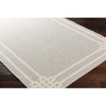 Tapis beige à motifs géométriques sur parquet