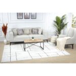 Salon moderne avec canapé, fauteuil et table basse.