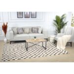 Salon moderne avec canapé, fauteuil et table basse.