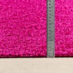 Tapis rose avec mètre pour mesurer l'épaisseur.