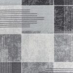 Tapis à motifs géométriques gris et blancs.