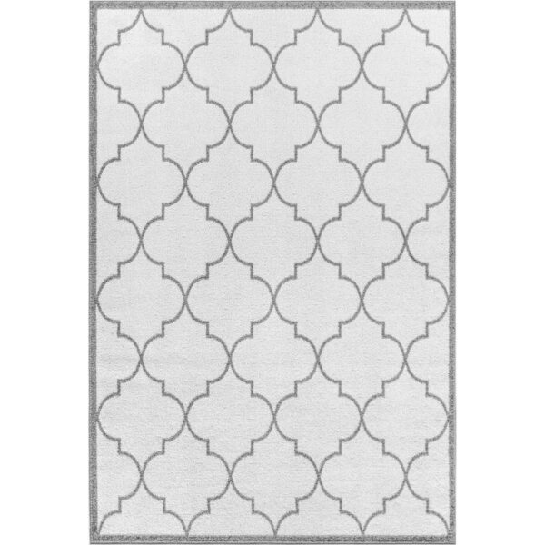 Tapis blanc à motifs géométriques gris.