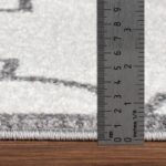 Règle mesurant épaisseur d'un tapis.