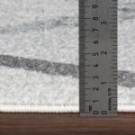 Règle mesurant l'épaisseur d'un tapis.