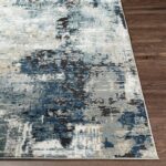 Tapis moderne aux nuances bleues et grises.