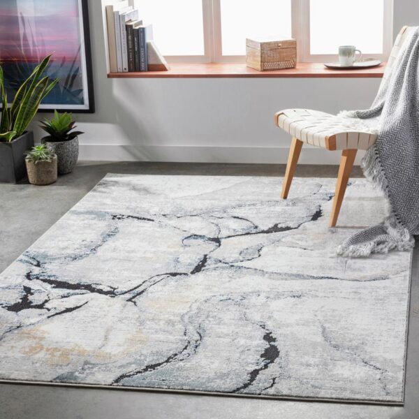 Tapis moderne gris et blanc dans salon épuré.