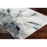 Tapis moderne gris et bleu sur plancher en bois