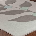 Tapis contemporain gris avec motifs géométriques.