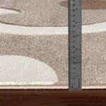 Règle mesurant l'épaisseur d'un tapis.