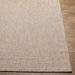 Tapis beige texturé sur plancher en bois.