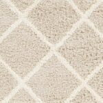 Textile beige en gros plan, motif géométrique.