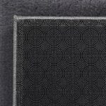 Tissu noir avec motif géométrique et bordure argentée.