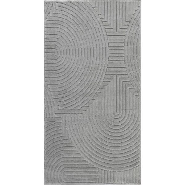 Tapis gris moderne avec motifs géométriques en relief.