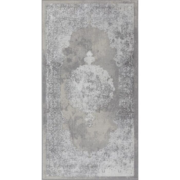 Tapis vintage gris à motif floral.