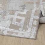 Tapis moderne gris et beige enroulé